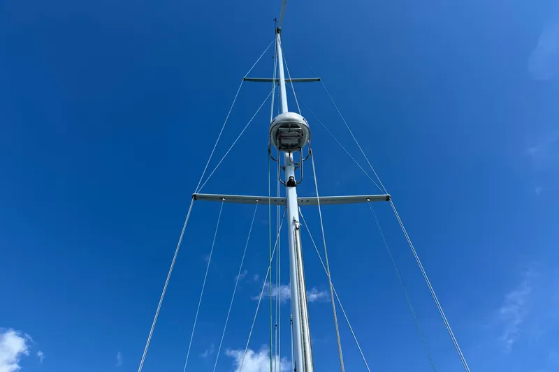 Slide: The Image of Tall mast of 1997 Tartan 3800 sailboat against clear blue sky. - 36