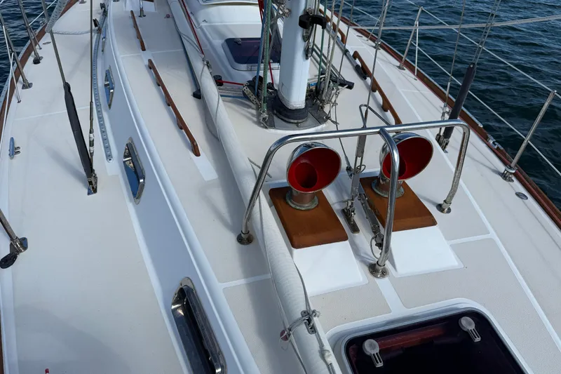 Slide: The Image of Deck view of a 1997 Tartan 3800 sailboat with red vents and polished fittings. - 37