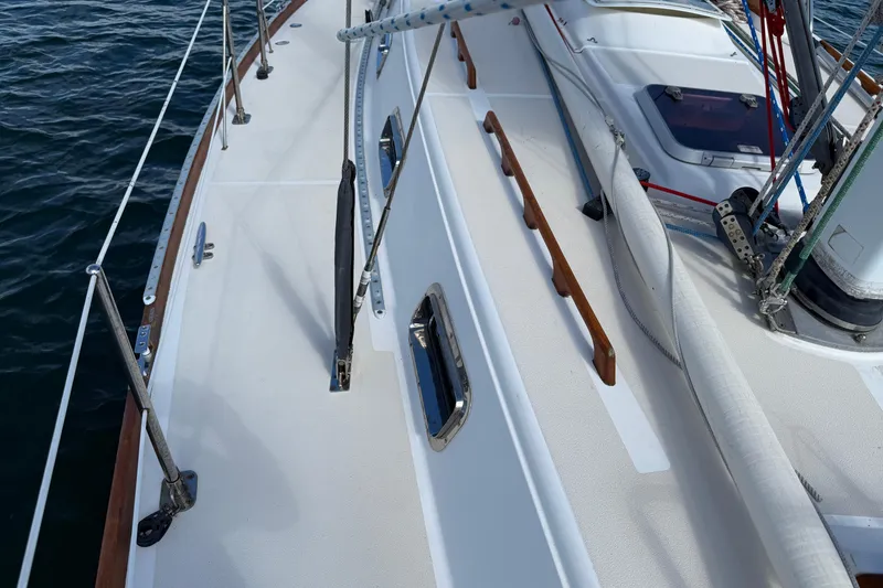 Slide: The Image of 1997 Tartan 3800 sailboat deck with rigging and wooden handrails. - 38