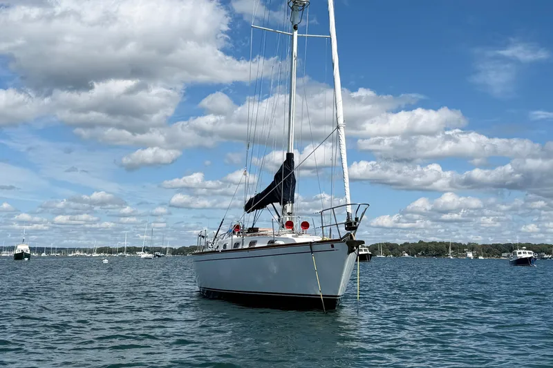 Slide: The Image of Sailboat Tartan 3800, 1997 model, anchored on a sunny day with scattered clouds. - 4