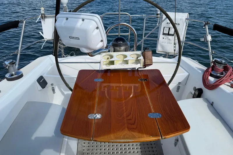 Slide: The Image of Cockpit of 1997 Tartan 3800 sailboat with wooden table and navigation equipment. - 41