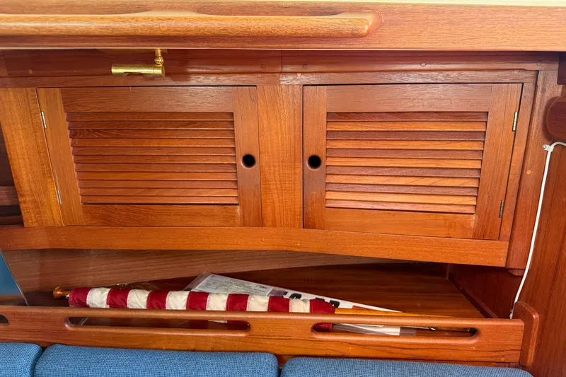 Slide: The Image of Wooden cabinet with louvered doors inside a 1997 Tartan 3800 sailboat. - 50