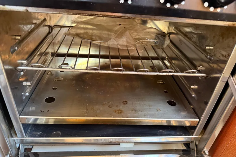 Slide: The Image of 1997 Tartan 3800 oven interior with metal racks and a plastic bag. - 59