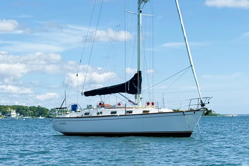 Slide: The Image of Sailboat Tartan 3800, 1997 model, anchored on calm water under a clear blue sky. - 6