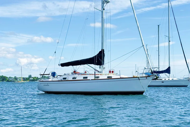 Slide: The Image of Sailboat Tartan 3800, 1997 model, anchored on calm water under a clear blue sky. - 7