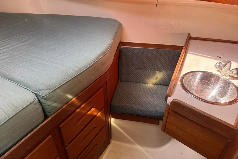 Slide: The Image of Interior of 1997 Tartan 3800 sailboat with bed, seat, and sink. - 70