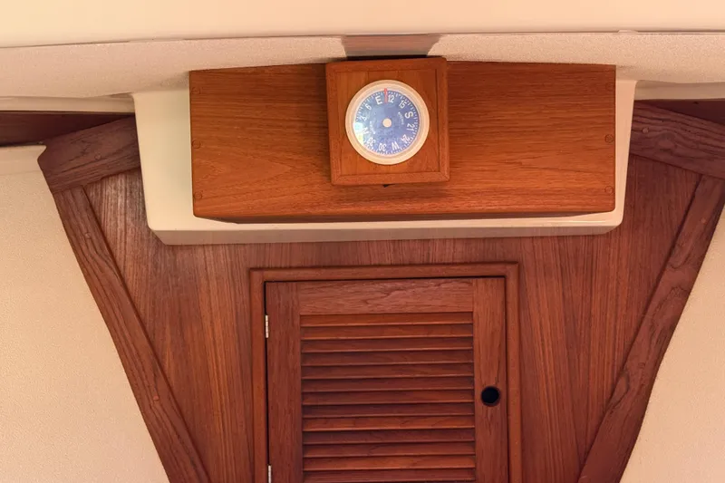Slide: The Image of Wooden interior of a 1997 Tartan 3800 sailboat with a nautical clock. - 72