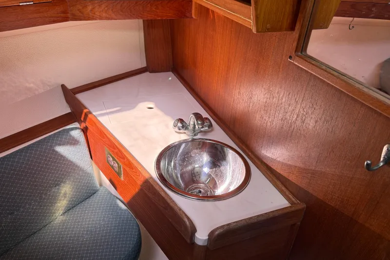 Slide: The Image of Interior of 1997 Tartan 3800 yacht with wooden cabinetry and stainless steel sink. - 73