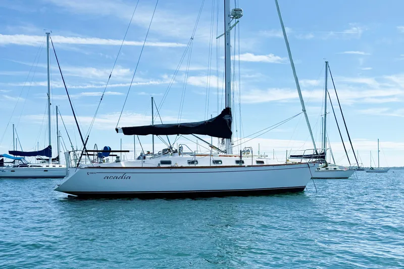 Slide: The Image of Sailboat Tartan 3800, 1997 model, anchored on calm blue waters under clear skies. - 8