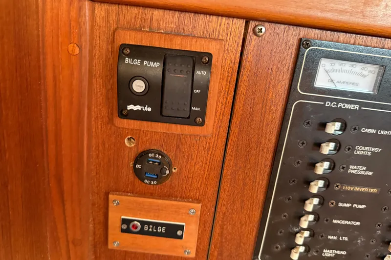 Slide: The Image of 1997 Tartan 3800 control panel with bilge pump and DC power switches. - 80