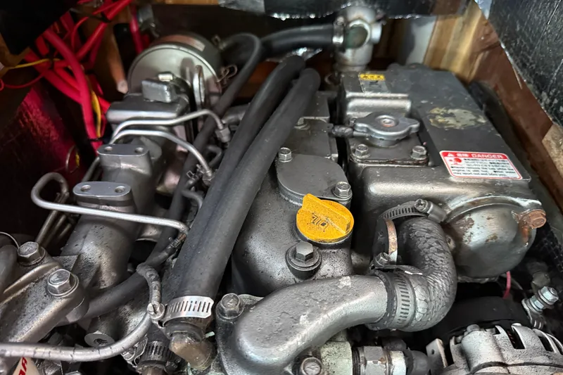 Slide: The Image of Engine compartment of a 1997 Tartan 3800, showcasing mechanical components and wiring. - 87