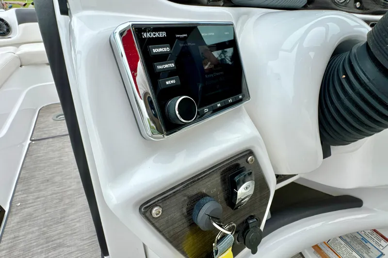 Slide: The Image of 2018 Rinker 29QX BR boat dashboard with Kicker audio system and controls. - 11