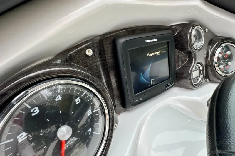 Slide: The Image of Dashboard of 2018 Rinker 29QX BR boat with Raymarine display and gauges. - 12