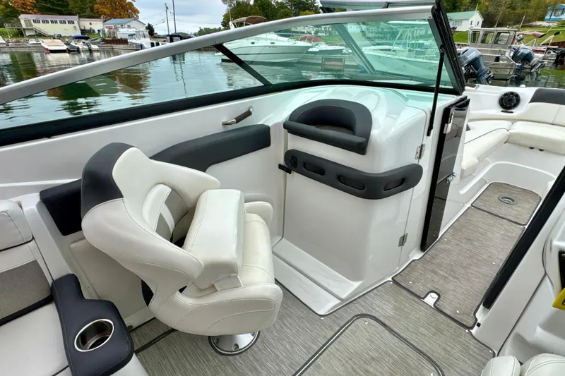 Slide: The Image of 2018 Rinker 29QX BR boat interior with white seating and modern design. - 14