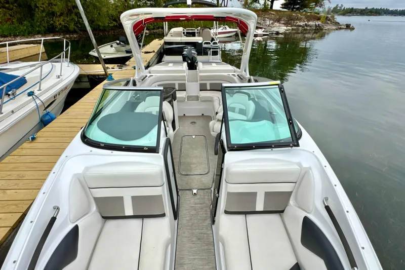 Slide: The Image of 2018 Rinker 29QX BR boat docked by a serene lake. - 20