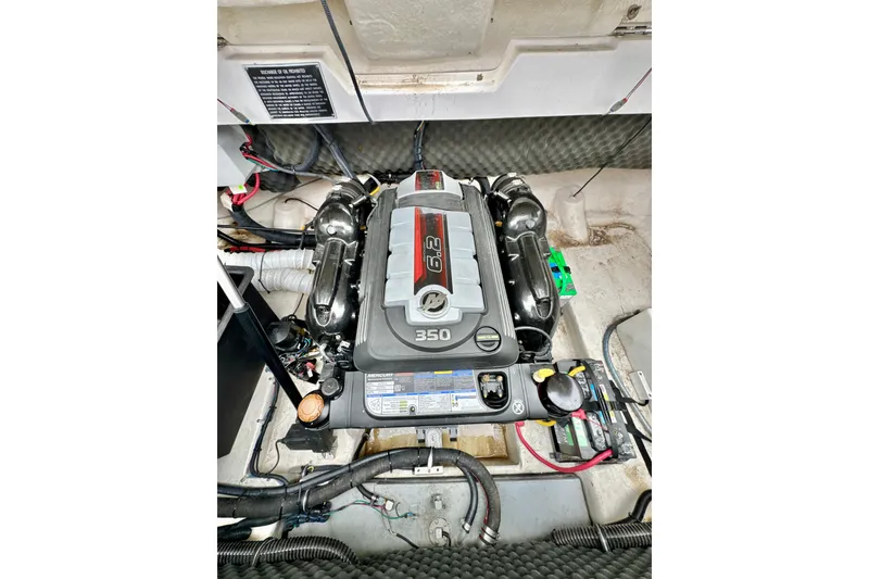Slide: The Image of Engine compartment of a 2018 Rinker 29QX BR boat, featuring a 350 horsepower engine. - 23
