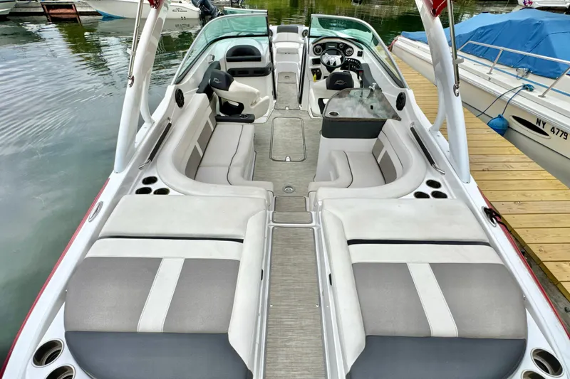 Slide: The Image of 2018 Rinker 29QX BR boat interior with spacious seating and modern dashboard. - 4