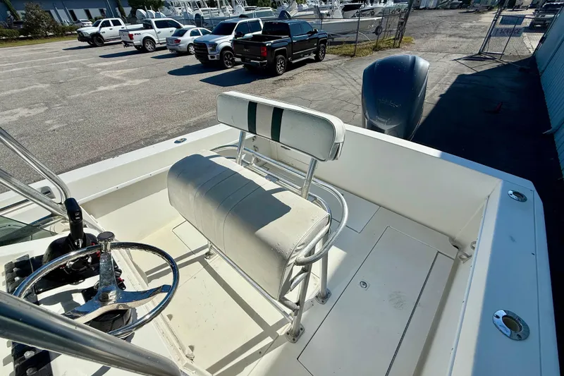 Slide: The Image of 1997 Contender 23 Open boat interior with steering wheel and seating. - 5