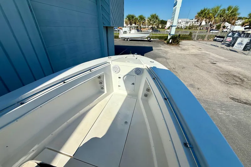 Slide: The Image of 1997 Contender 23 Open boat, spacious deck, docked near palm trees. - 8