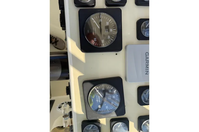 Slide: The Image of Dashboard of a 2002 Carolina Classic 28 boat with gauges and Garmin device. - 10