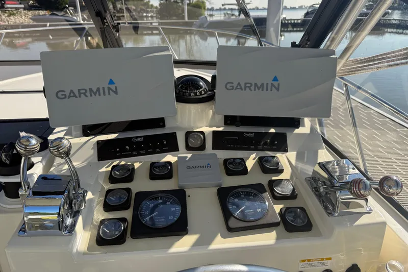 Slide: The Image of Control panel of a 2002 Carolina Classic 28 boat with Garmin navigation displays. - 13