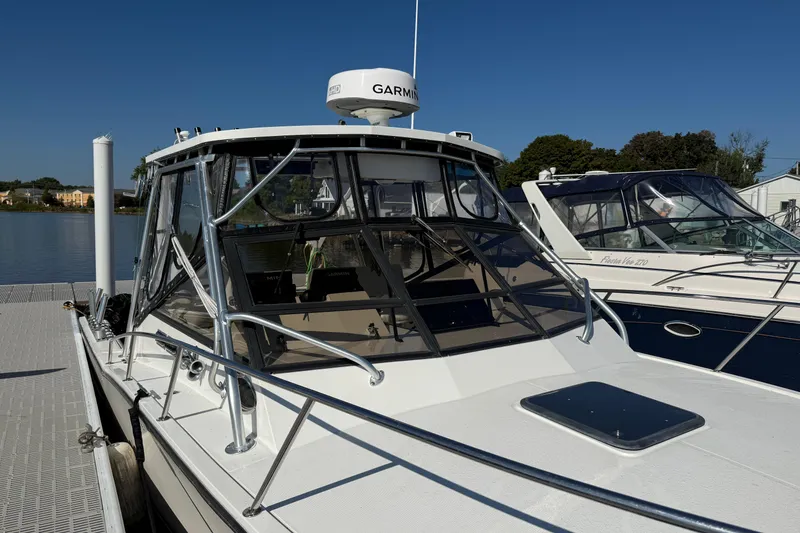 Slide: The Image of 2002 Carolina Classic 28 boat docked with Garmin radar, clear blue sky. - 6