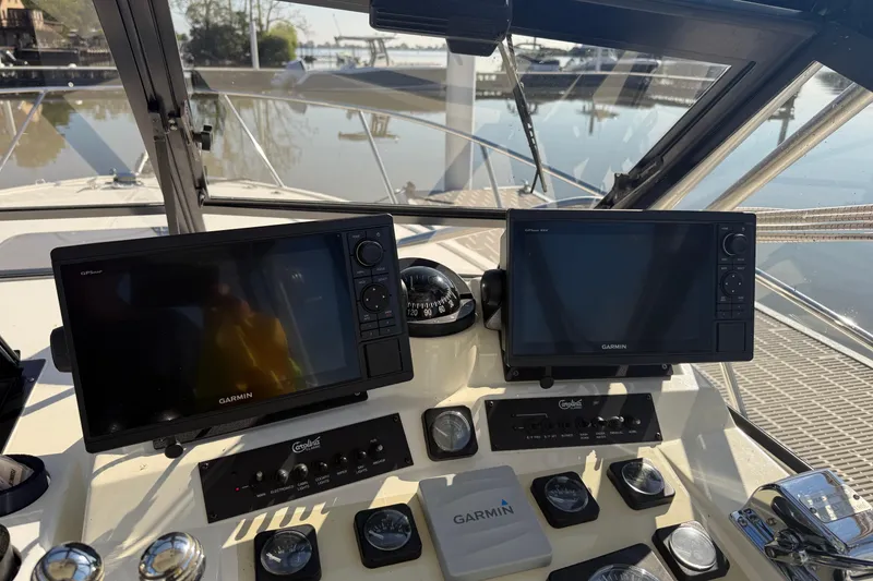 Slide: The Image of Helm of 2002 Carolina Classic 28 with Garmin navigation displays and controls. - 8