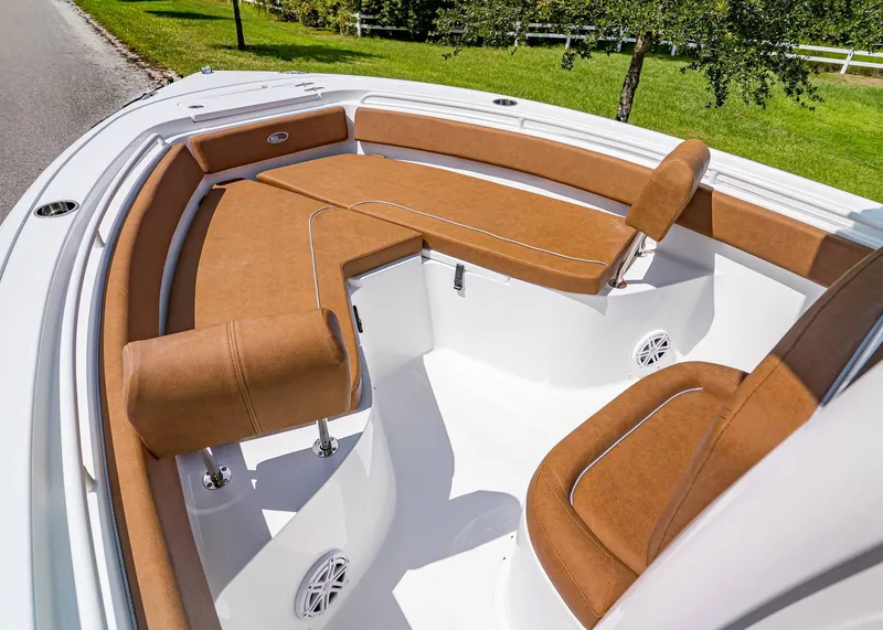 Slide: The Image of 2026 Sea Hunt Ultra 239 boat interior with brown cushioned seating and white deck. - 19