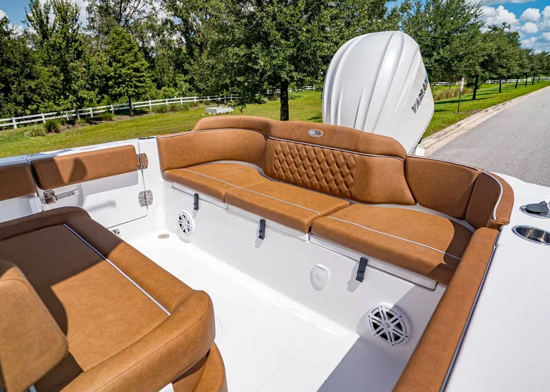 Slide: The Image of 2026 Sea Hunt Ultra 239 boat interior with brown cushioned seating and white deck. - 7