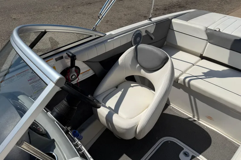 Slide: The Image of 2014 Bayliner 185 Bowrider interior with white seating and steering wheel. - 12