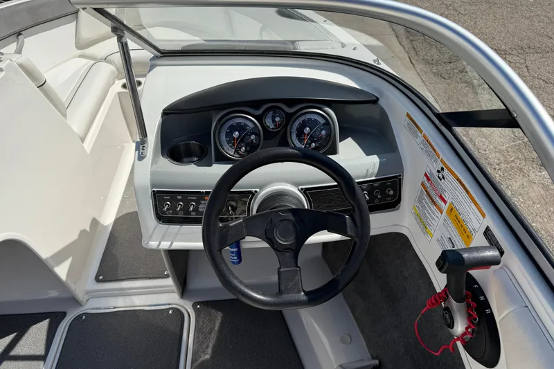 Slide: The Image of 2014 Bayliner 185 Bowrider dashboard with steering wheel and control panel. - 15