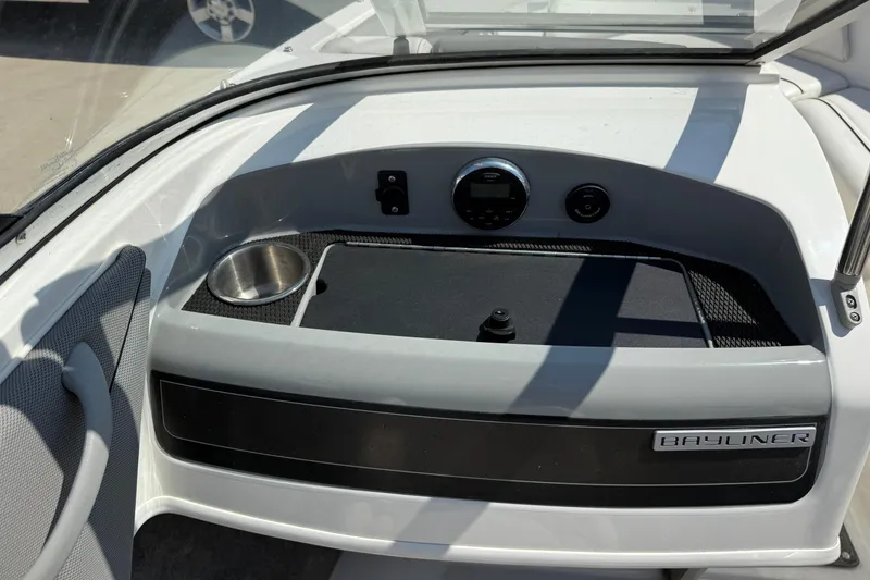 Slide: The Image of 2014 Bayliner 185 Bowrider dashboard with cup holder and control panel. - 17