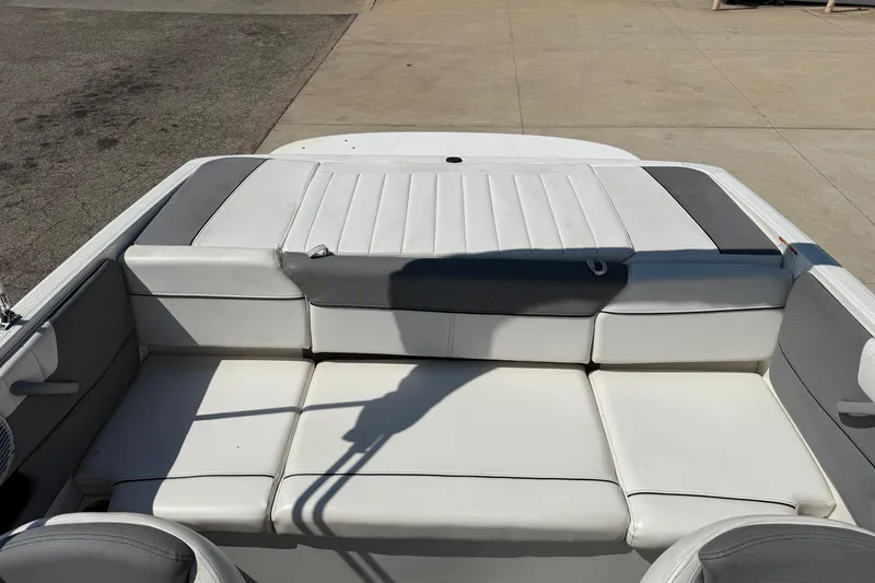 Slide: The Image of 2014 Bayliner 185 Bowrider boat interior with white and gray seating. - 19