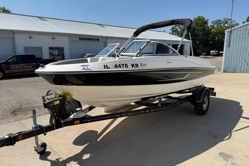 Slide: The Image of 2014 Bayliner 185 Bowrider on trailer outside showroom, sunny day. - 2
