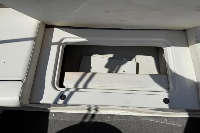 Slide: The Image of 2014 Bayliner 185 Bowrider storage compartment with open lid, showcasing interior space. - 20