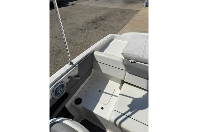 Slide: The Image of 2014 Bayliner 185 Bowrider interior with white seating and speaker detail. - 22