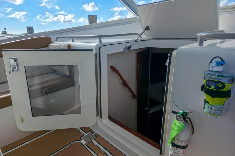 Slide: The Image of 2005 Buddy Davis 35' Express boat interior with open cabin door and safety equipment. - 12