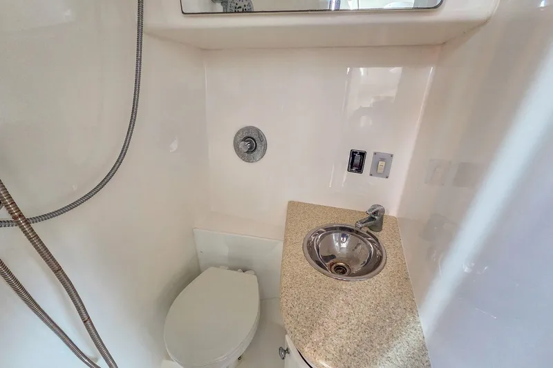 Slide: The Image of Compact bathroom in 2005 Buddy Davis 35' Express boat with sink and toilet. - 18