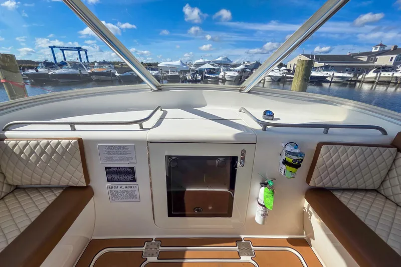 Slide: The Image of 2005 Buddy Davis 35' Express boat interior with quilted seating and marina view. - 23