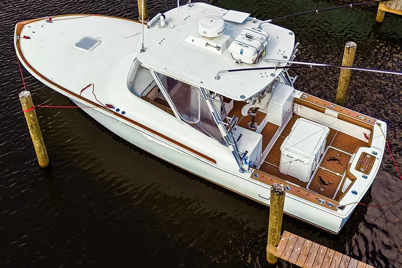 Slide: The Image of 2005 Buddy Davis 35' Express boat docked, aerial view, showcasing spacious deck and sleek design. - 31