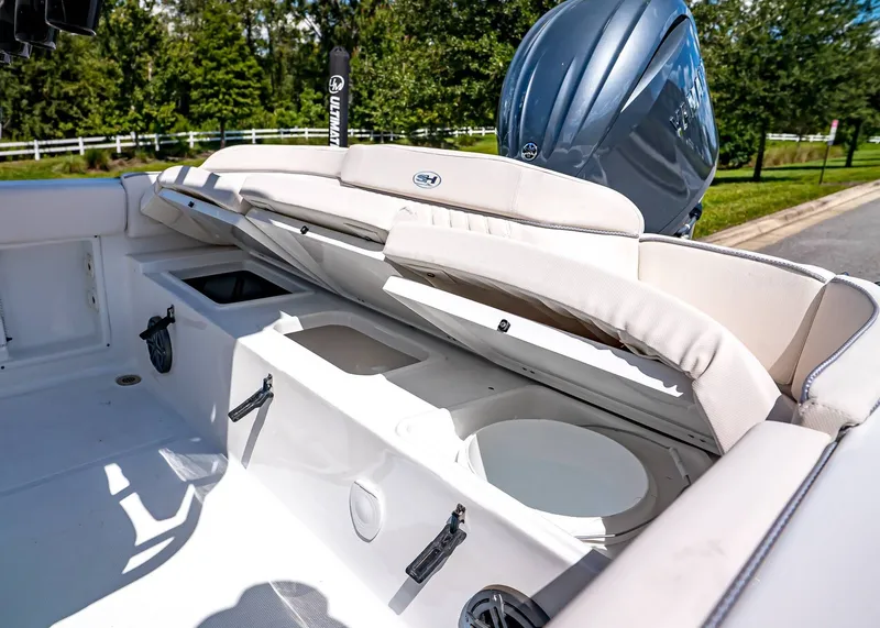 Slide: The Image of 2026 Sea Hunt Ultra 219 boat interior with open storage compartments and seating. - 12