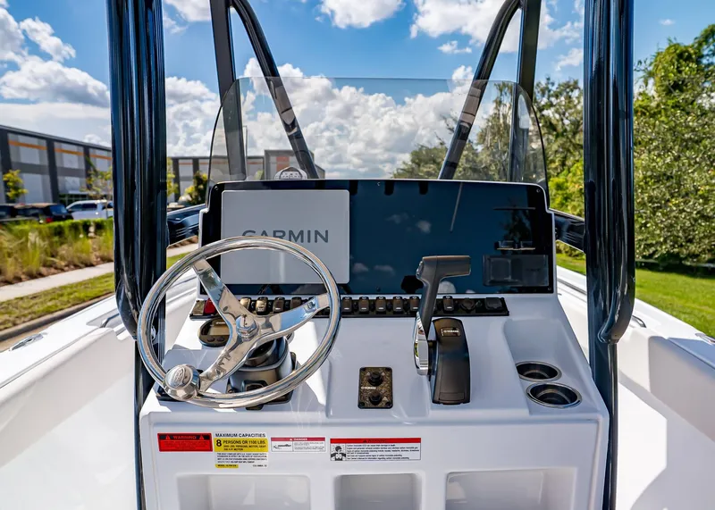 Slide: The Image of 2026 Sea Hunt Ultra 219 boat console with Garmin navigation, steering wheel, and controls. - 15