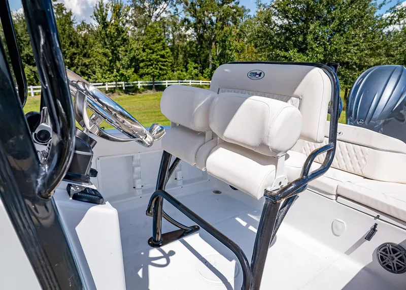 Slide: The Image of 2026 Sea Hunt Ultra 219 boat interior with white seating and steering wheel. - 17