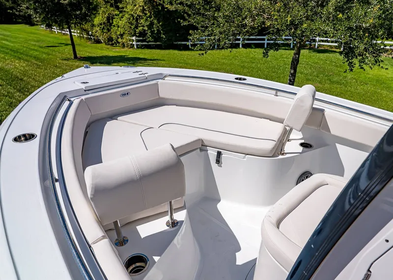 Slide: The Image of 2026 Sea Hunt Ultra 219 boat interior with cushioned seating and cup holders. - 25