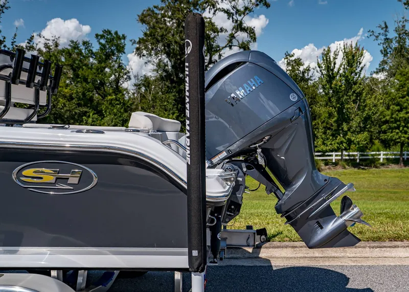 Slide: The Image of Sea Hunt Ultra 219 boat with Yamaha outboard motor, 2026 model, parked outdoors. - 3
