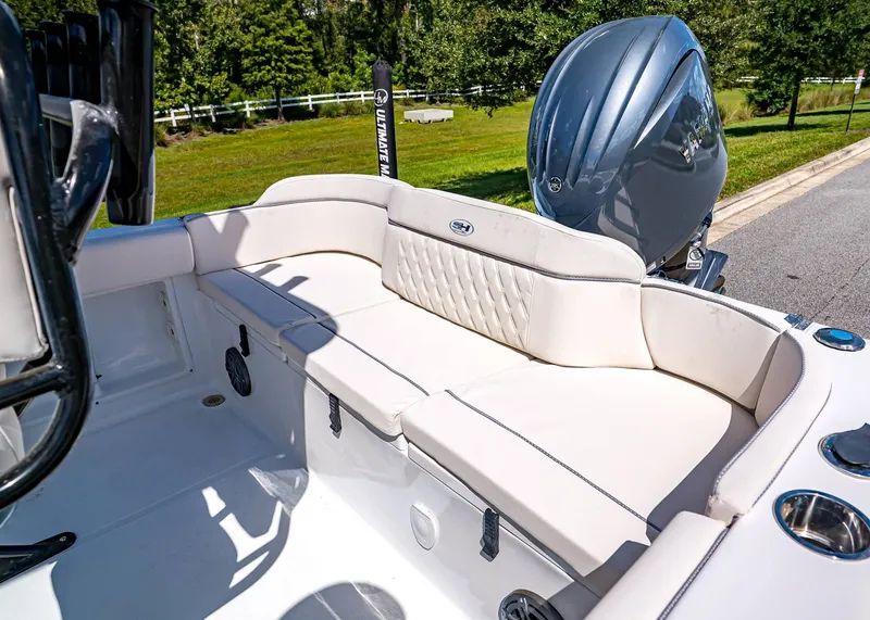 Slide: The Image of 2026 Sea Hunt Ultra 219 boat with cushioned seating and powerful outboard motor. - 7