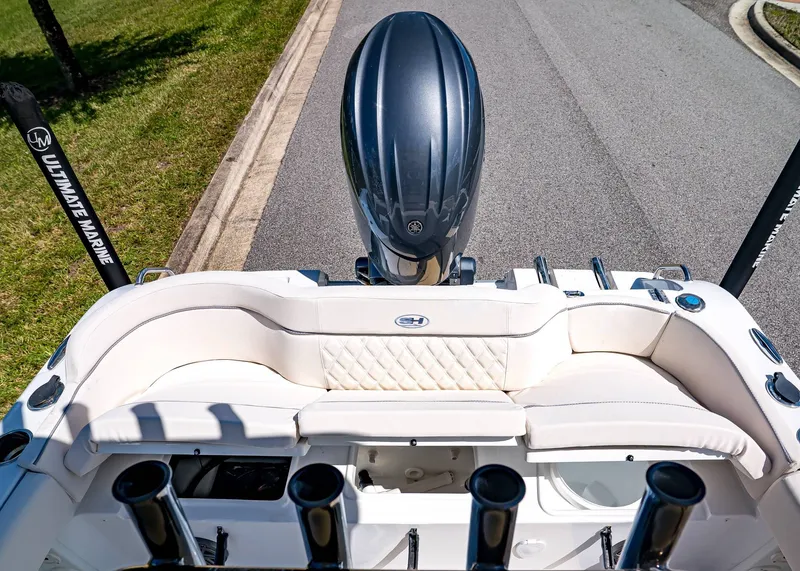 Slide: The Image of 2026 Sea Hunt Ultra 219 boat with cushioned seating and outboard motor. - 8