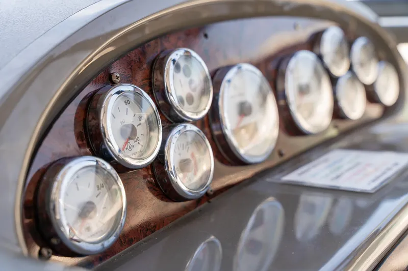 Slide: The Image of Dashboard of 2008 Regal Commodore 4060 boat with multiple gauges and dials. - 11