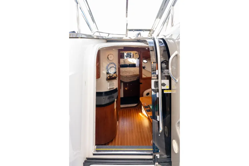 Slide: The Image of Interior view of 2008 Regal Commodore 4060 yacht, featuring elegant wood finishes and cozy cabin. - 15