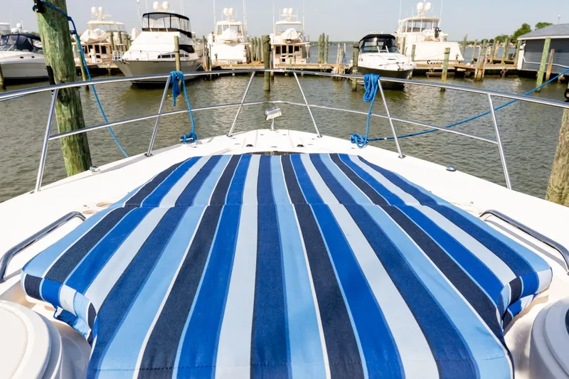 Slide: The Image of 2008 Regal Commodore 4060 yacht with striped deck, docked at marina. - 21